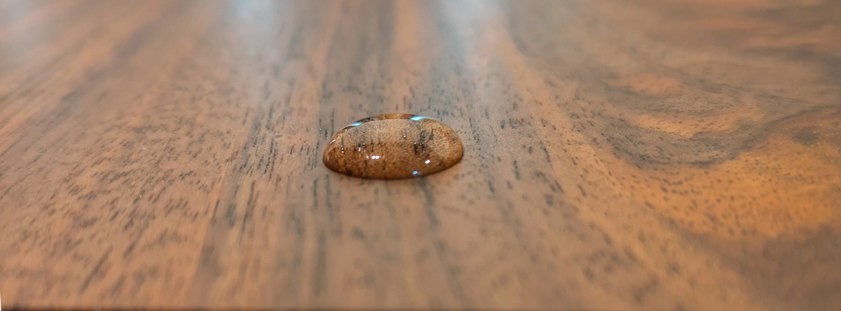 Bead of water on a walnut surface